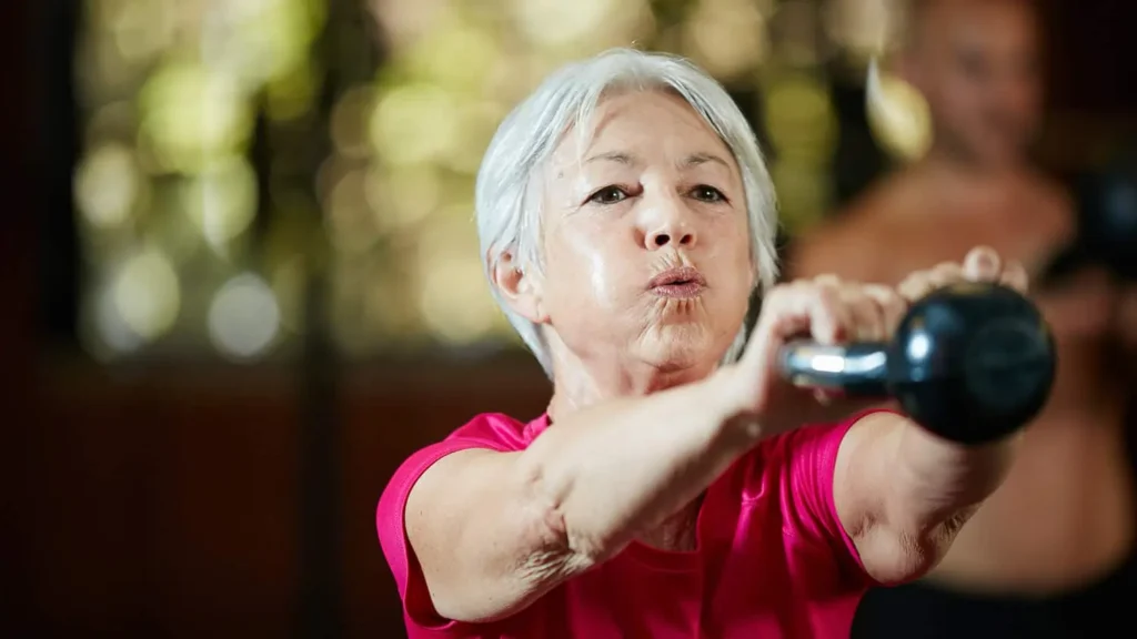 Toning Arms Without the Bulk: Is It Achievable? 1 Woman doing resistance band exercises for toned arms Walsall